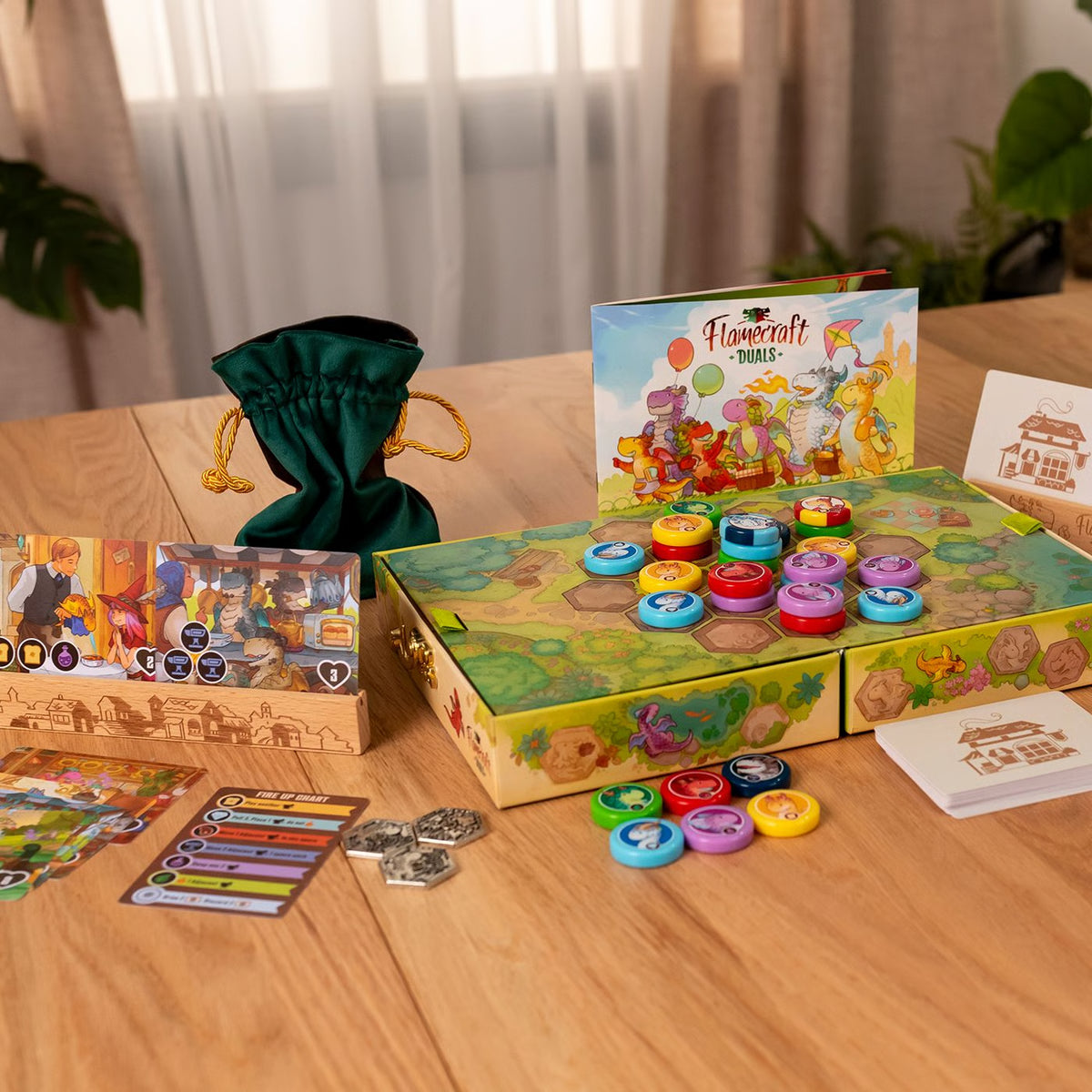 Flamecraft duals deluxe game components, with colorful buttons and accessories on a wooden table.